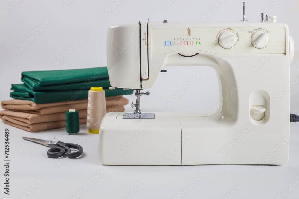 Fabric, scissors and thread for using a sewing machine.