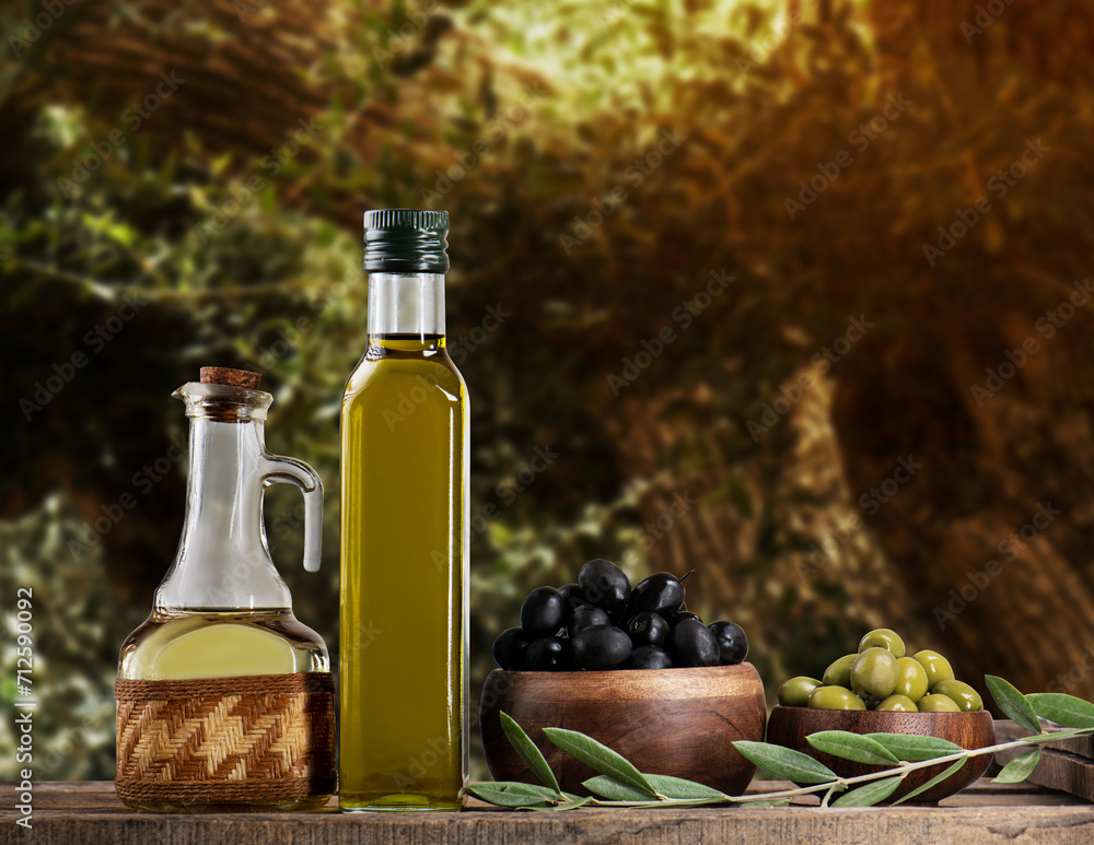 Olive oil and olives in the olive tree background Olive oil and olives in the olive tree background