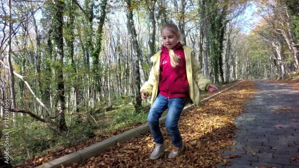happy girl running through autumn yellow leaves happy girl running through autumn yellow leaves