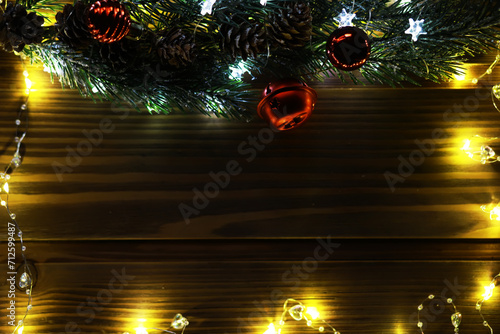 Christmas fir tree with decoration on dark wooden board background. Border art design with Christmas tree