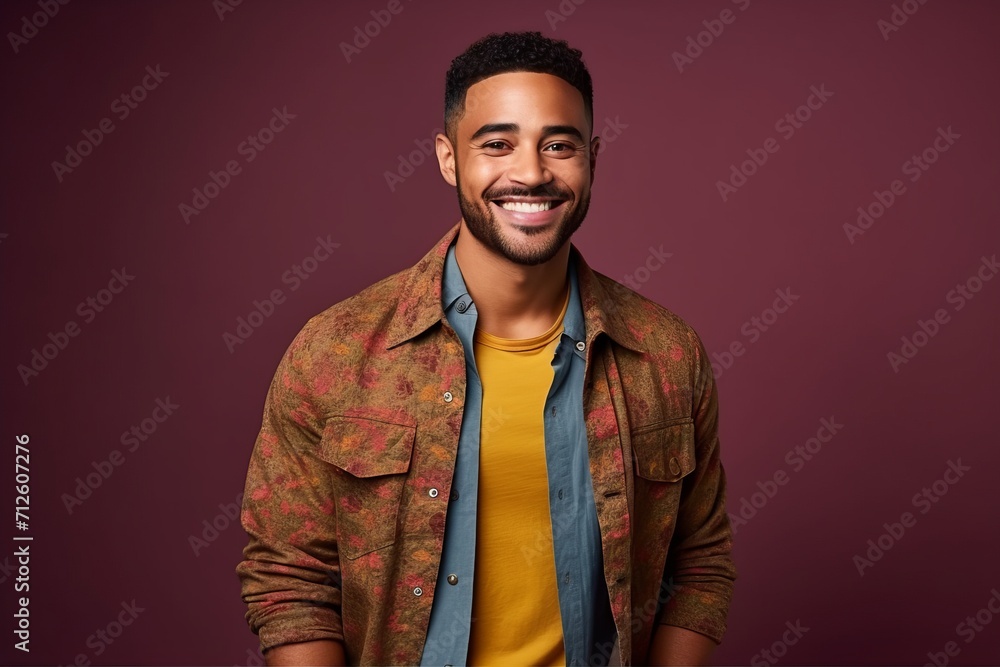 Portrait of a handsome young african american man smiling against purple background Portrait of a handsome young african american man smiling against purple background