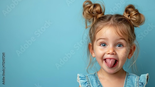 A little girl is making a face sticking her tongue out on clean backdrop, space, Generative AI. photo