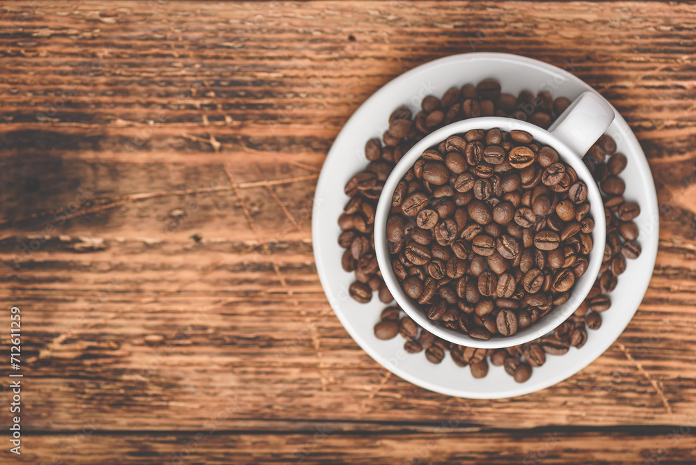 Cup full of roasted coffee beans Cup full of roasted coffee beans