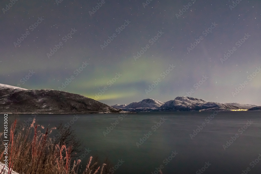 Aurora borealis or Northern lights in the sky over Tromso - Norway