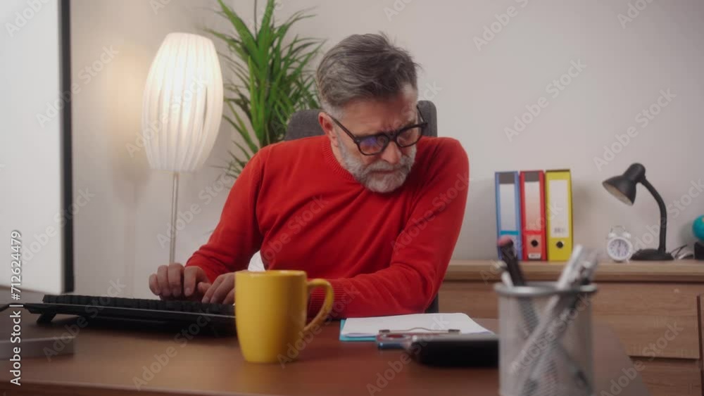Shot of businessman using desktop, typing on keyboard, sitting at wooden desk with documents, writing email, accountant writing financial report, busy studying online, searching information Shot of businessman using desktop, typing on keyboard, sitting at wooden desk with documents, writing email, accountant writing financial report, busy studying online, searching information