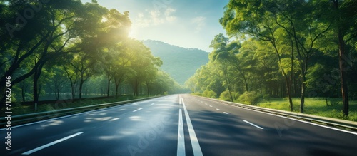 Empty asphalt road and blurred speed movement on highway in rural forest photo