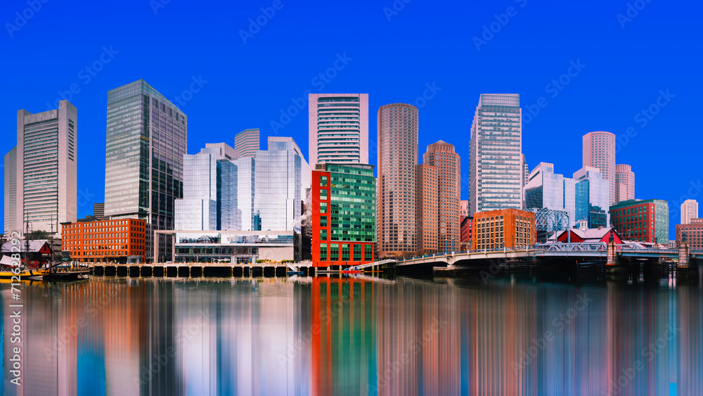 Boston City Skyline, skyscrapers and water reflections on the Charles River with the Blue Sky backgrounds in Massachusetts, USA