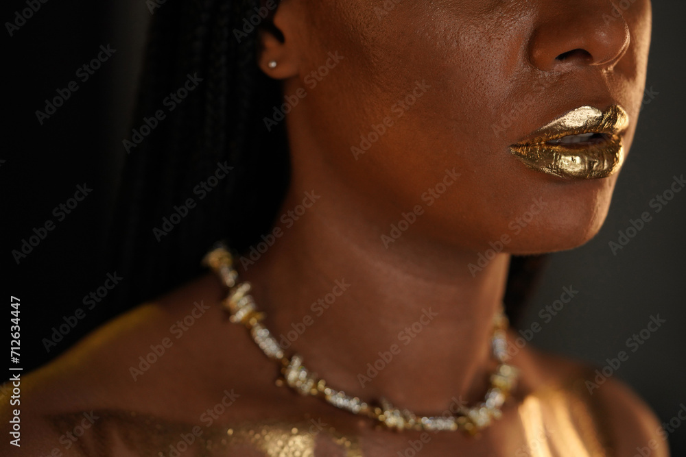 Portrait of an African American woman with a gold necklace around her ...