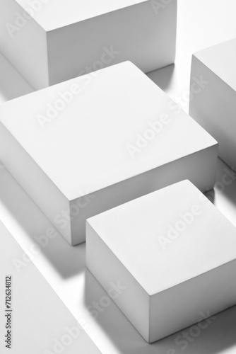 Gorgeous white cubes on flat surface with cast shadow, podium for products presentation, mockup. Stage for showcase. 