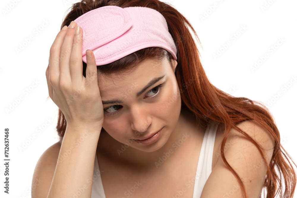 Portrait of dissappointed lonely crying beautiful woman with long straight ginger hair on a white background Portrait of dissappointed lonely crying beautiful woman with long straight ginger hair on a white background