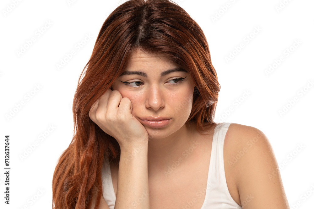 Portrait of dissappointed lonely crying beautiful woman with long straight ginger hair on a white background Portrait of dissappointed lonely crying beautiful woman with long straight ginger hair on a white background