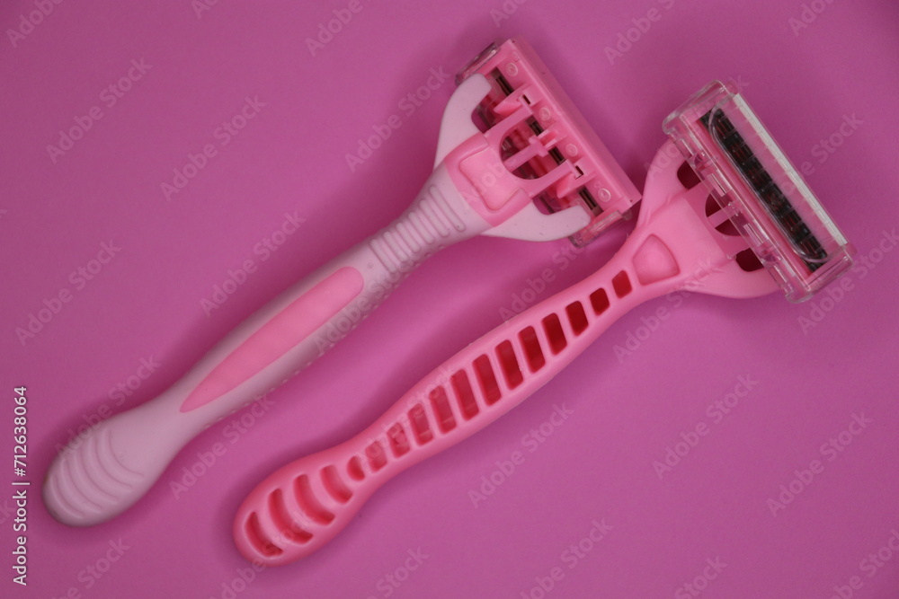 pink women's razors with five blades on a pink background pink women's razors with five blades on a pink background