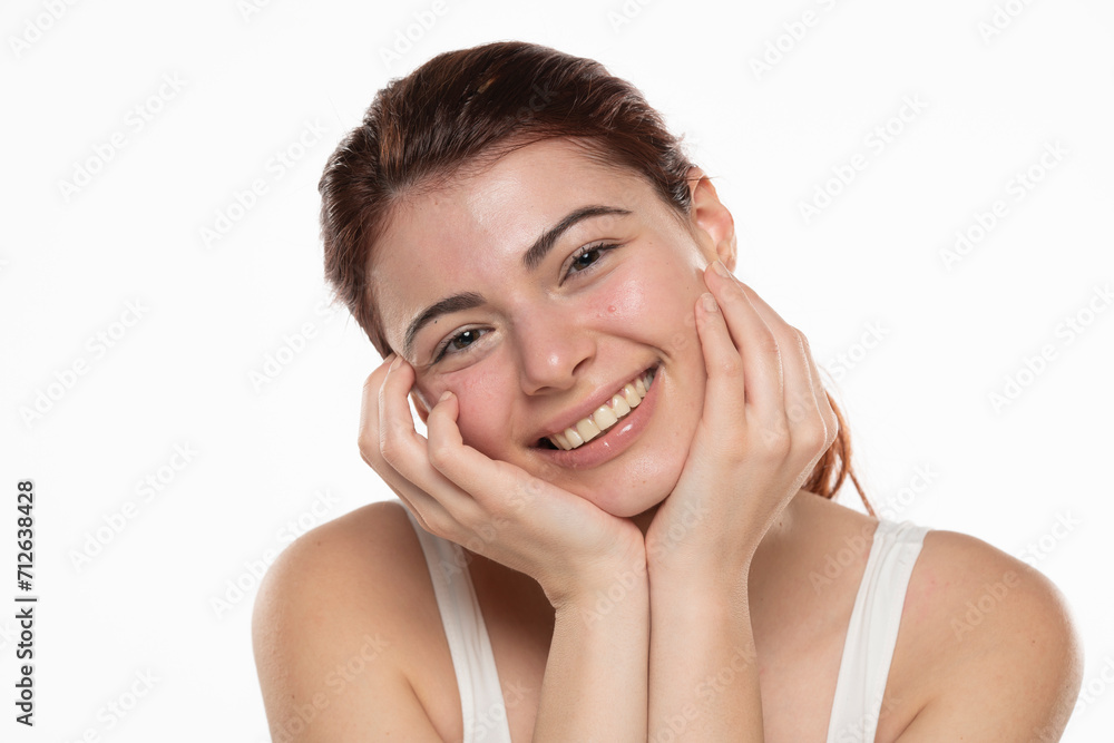 a young happy redhead woman without makeup with long hair on a white background a young happy redhead woman without makeup with long hair on a white background