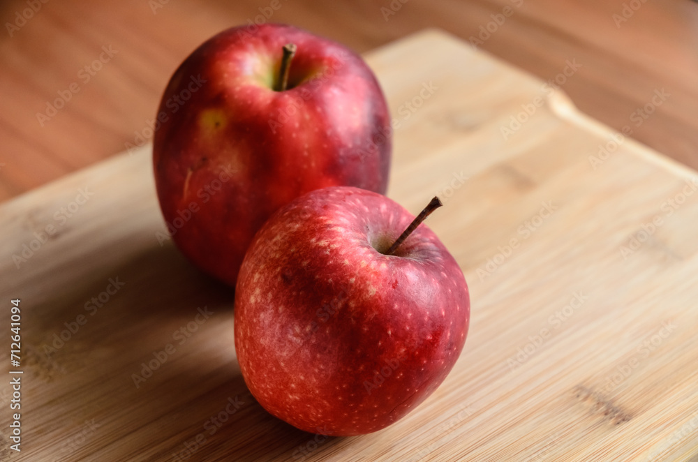 Red and yellow apples on wooden cutting board in the kitchen, healthy diet Vitamin C fruit Red and yellow apples on wooden cutting board in the kitchen, healthy diet Vitamin C fruit