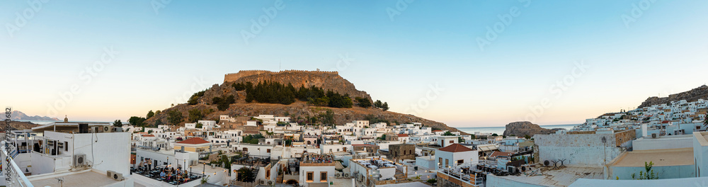 Panoramic view of the ancient Acropolis of Lindos and snow white houses.