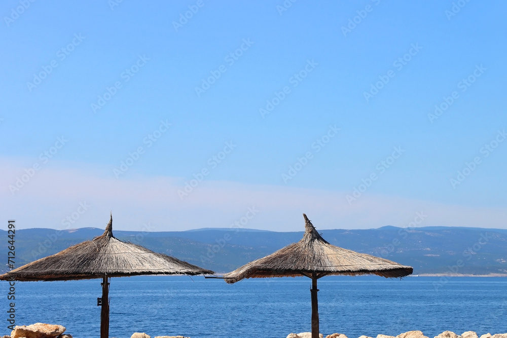 Wicker parasol on the beautiful beach in Brela, Croatia.