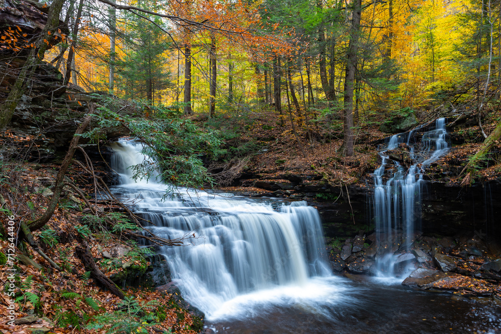 Cascade of waterfalls in a mountain gorge, fast flowing water, long exposure