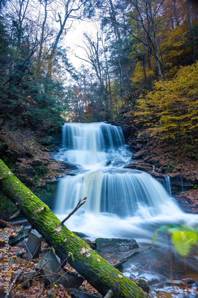 Obraz premium Cascade of waterfalls in a mountain gorge, fast flowing water, long exposure