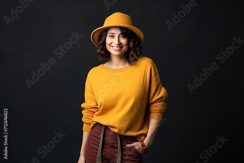 Portrait of a beautiful young woman in a yellow sweater and hat