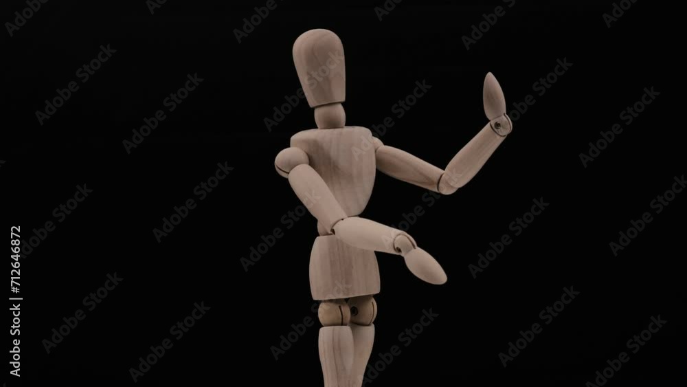 Wood mannequin over black background rotating Wood mannequin over black background rotating