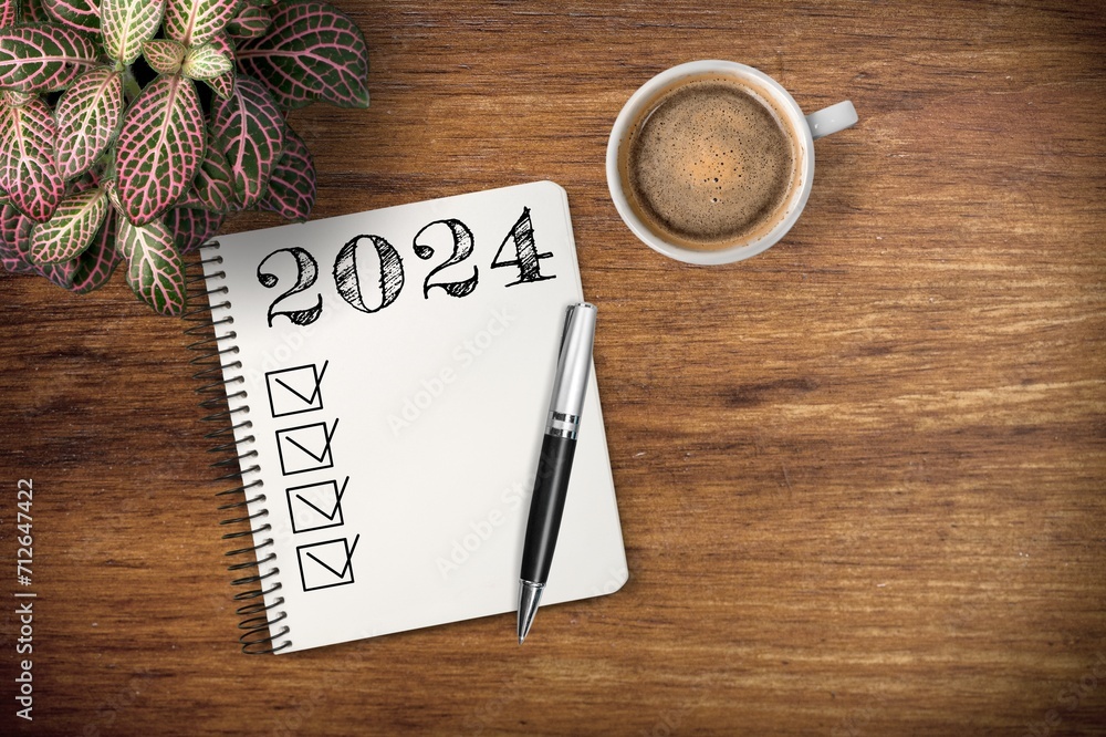 New year 2024 resolutions on notebook at desk New year 2024 resolutions on notebook at desk