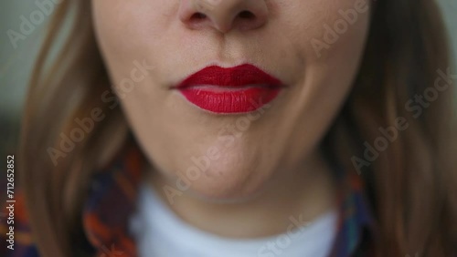 Close up of healthy woman with red lips eating walnuts seeds dried fruit indoor at home. High quality FullHD footage