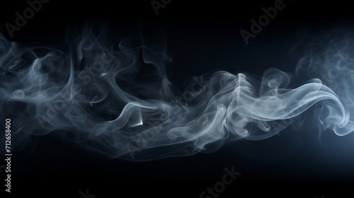 Smoke is visible in the spotlight on a black background.
