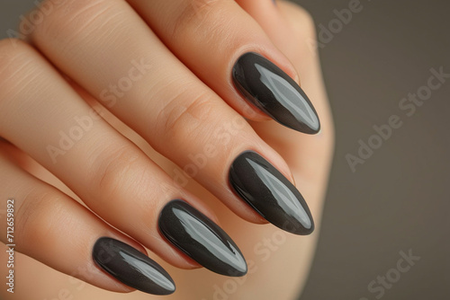Elegance at your fingertips: Glamorous woman's hand adorned with chic gray nail polish, showcasing a flawless gel manicure at a luxury beauty salon. French manicure perfection.