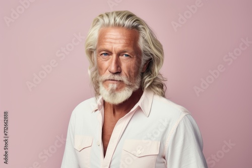 Portrait of senior man with grey hair and beard. Studio shot.