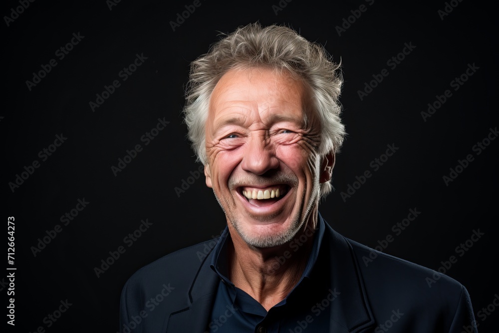 Portrait of a happy senior man laughing on a black background. Portrait of a happy senior man laughing on a black background.