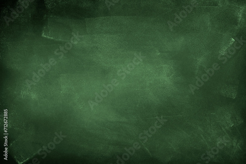 Chalk rubbed out on green chalkboard background photo