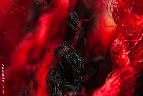 Close-up View of a Red Textured Fabric Surface With Visible Fibers