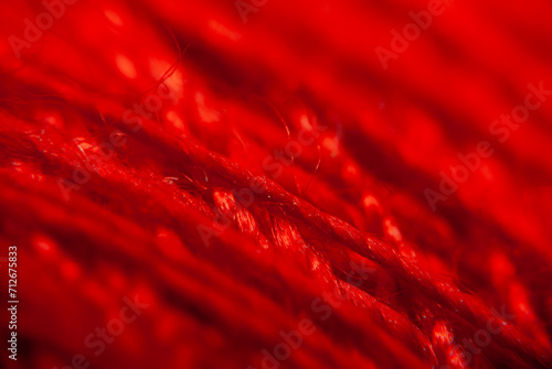 Close-up View of a Red Textured Fabric Surface With Visible Fibers