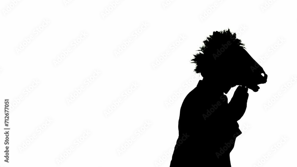 Black silhouette of man in business suit with horse head mask on white isolated studio background. Businessman dancing merrily. Concept of hard office work. Black silhouette of man in business suit with horse head mask on white isolated studio background. Businessman dancing merrily. Concept of hard office work.