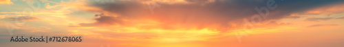 extra wide panoramic fiery sunset sky. Vibrant gradient tones. poster banner landing page background design. Vibrant fantasy colorful cloudscape. Orange and yellow gradient sky