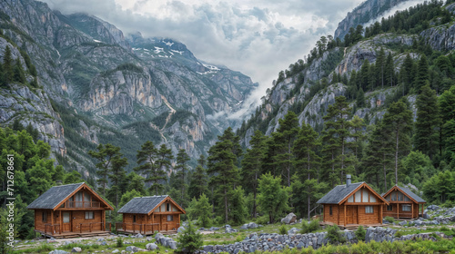 Mountain cabins by a forest clearing. © RISHAD