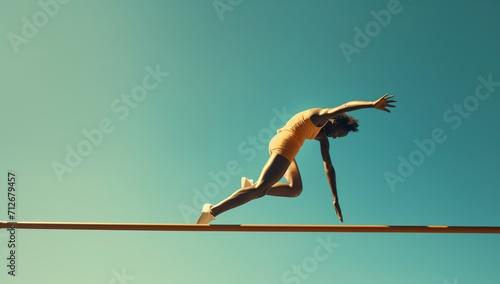 Female athlete hurdling over a hurdle during a track and field event photo