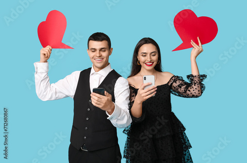 Happy couple using smartpho...
