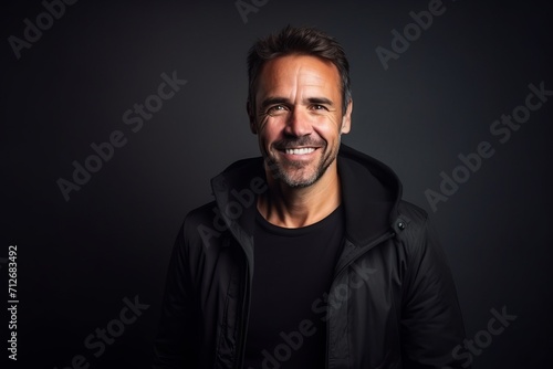 Portrait of a handsome man in a black jacket on a dark background