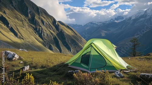 A green tent pitched up in the mountains © Friedbert