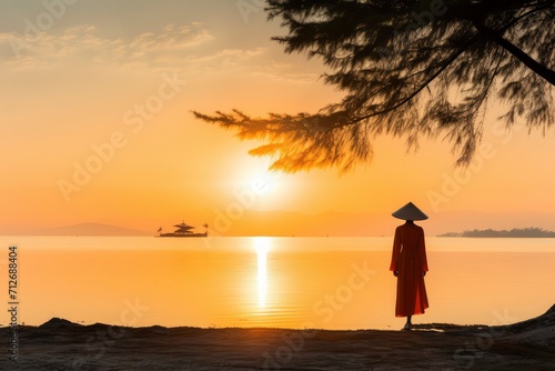 Person Standing on Beach, Watching Sun Set in Peaceful Evening Scene