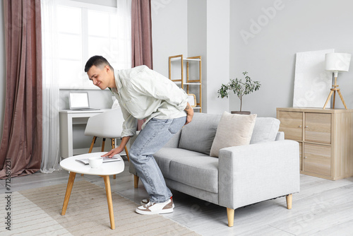 Young man with hemorrhoids at home photo