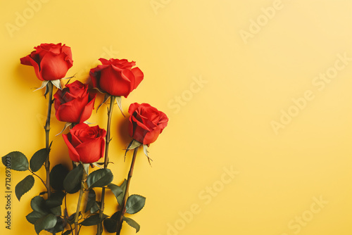 Red beautiful roses on yellow background