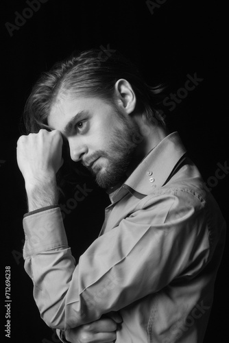 Black and white portrait of a young man with a beard.