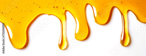 Horizontal image of honey drips on a white background