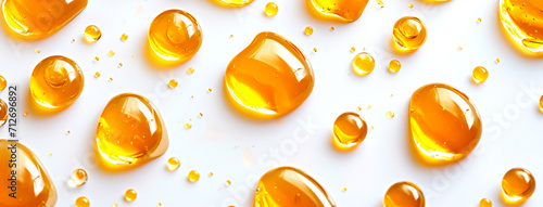 Horizontal image of honey drips on a white background