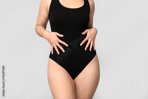 Body positive young woman on light background, closeup