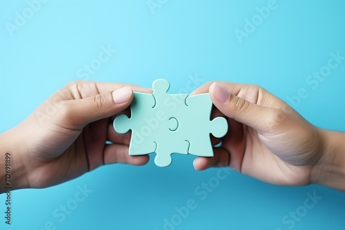Two hands holding a puzzle piece to complete the puzzle