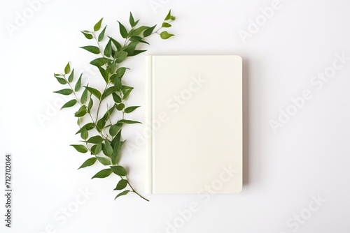 Old retro book with green leafs on white background photo