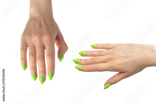 Hand of a woman with green naols hold some tiny or thin object.